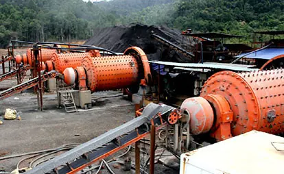 Orange ball mills and belt conveyor at a processing plant