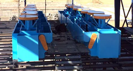 Row of blue flotation cells on a steel platform